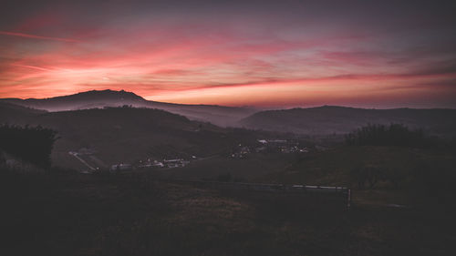 Scenic view of silhouette mountains against sky during sunset