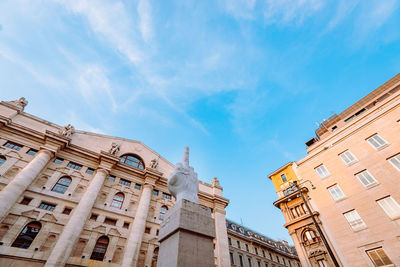 Wide angle view of piazza degli affari in milan with famous artwork in the center