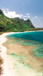 Scenic view of sea and mountains against sky