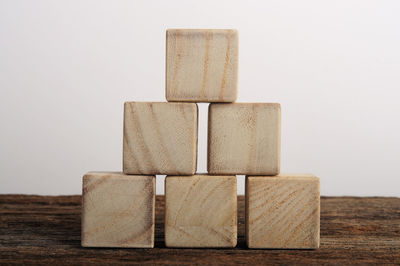 Close-up of wooden blocks against white background on table