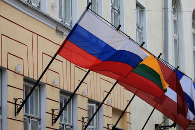 Low angle view of flag against buildings in city