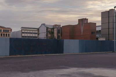 Buildings in city against sky during sunset