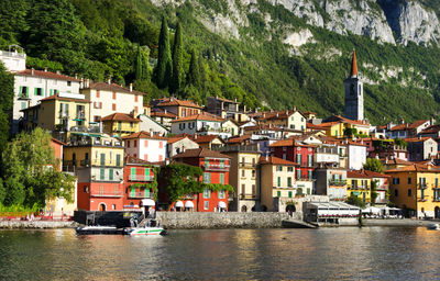 Calm lake against built structures on landscape