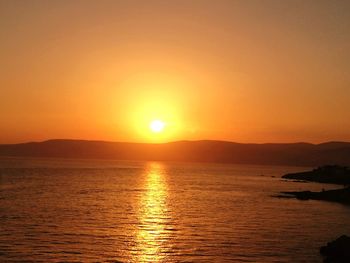 Scenic view of sea against orange sky