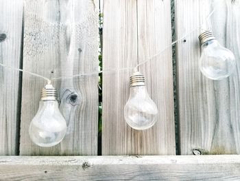 Close-up of light bulbs hanging on table