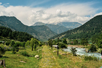 Scenic view of landscape and mountains against sky