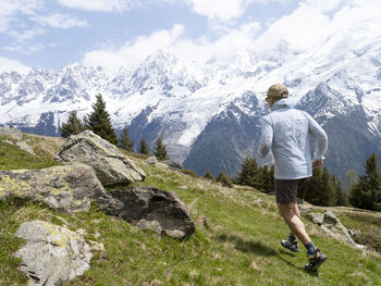 Man hiking near snowcapped mountains