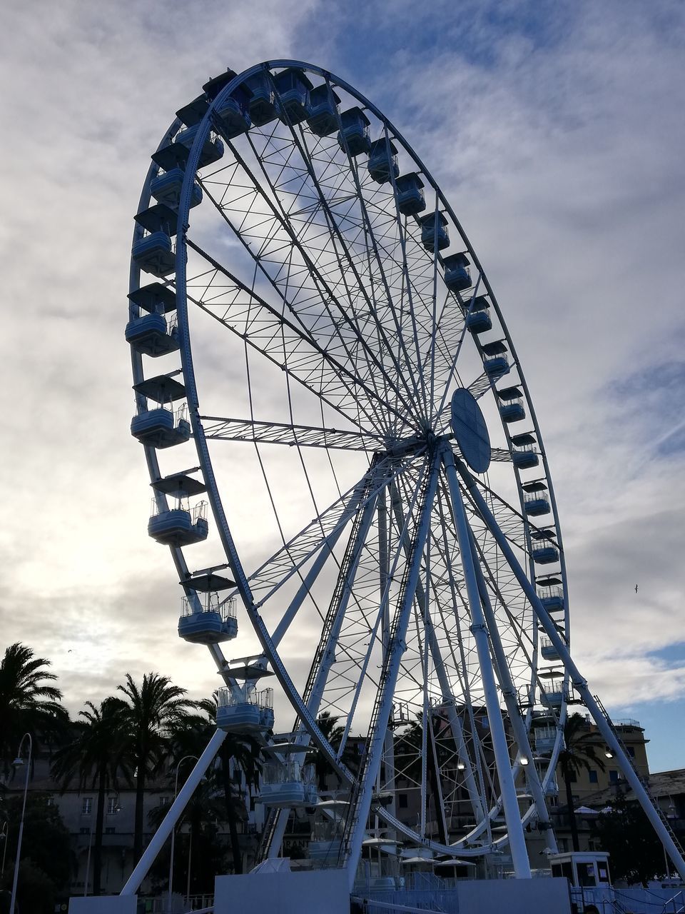 FERRIS WHEEL AGAINST CLOUDY SKY