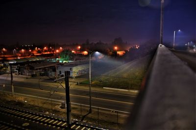 Train on railway tracks against sky at night