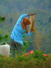 Side view of woman working in basket