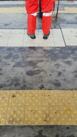 Low section of man with umbrella on road