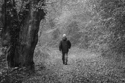 Rear view of person walking in tunnel