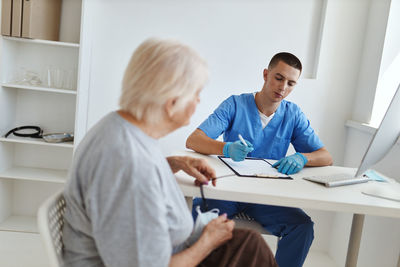 Doctor explaining to daughter at home