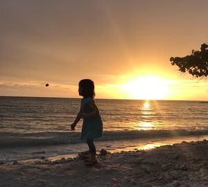 Full length of man standing on beach during sunset