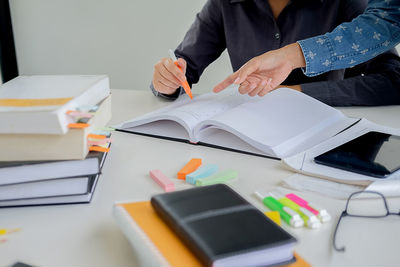 Close-up of man working on book