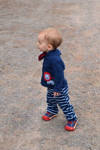 High angle view of cute boy standing outdoors
