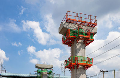 Low angle view of communications tower against sky