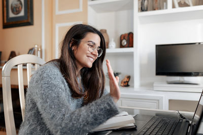 Young woman using mobile phone at home