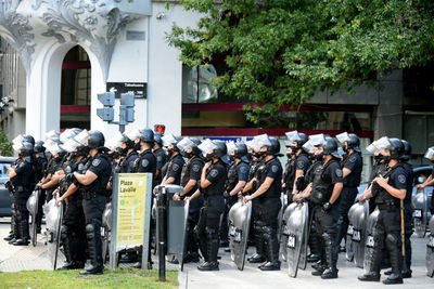 Police officers with shields and helmets