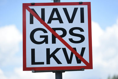 Low angle view of road sign against sky