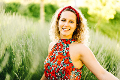 Portrait of smiling woman standing on field