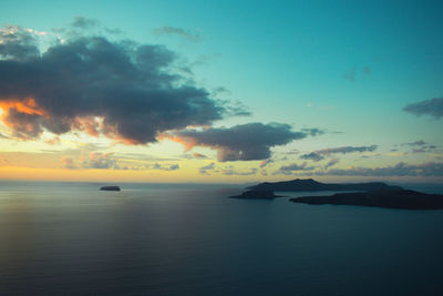 Scenic view of sea against dramatic sky during sunset