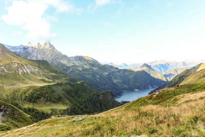 Scenic view of lake and mountains against sky