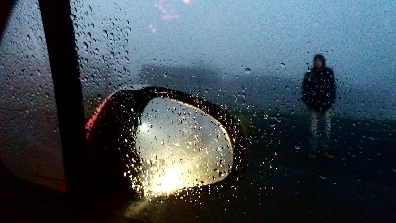 CLOSE-UP OF WET WINDOW WITH RAIN DROPS