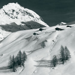 Snow covered landscape against sky