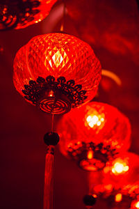 Low angle view of illuminated lanterns hanging from ceiling