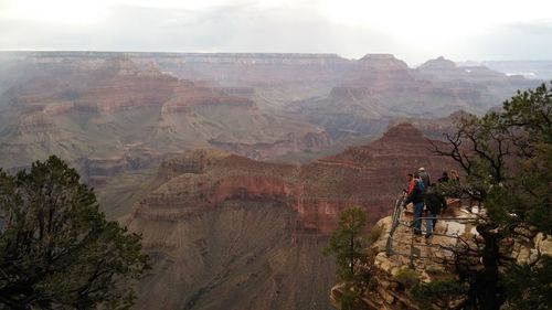 People at observation point against sky