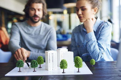 Business people discussing over architectural model