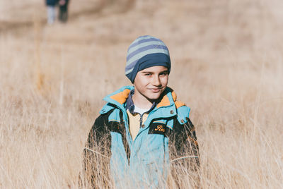 Portrait of happy boy on field