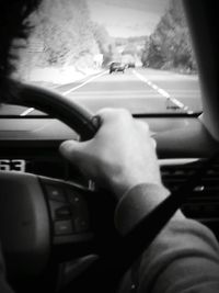 Cropped image of woman driving car