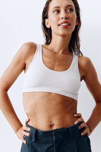 Midsection of woman standing against white background