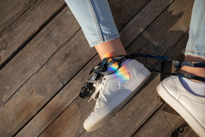 Low section of woman with tape tangled sitting on wood