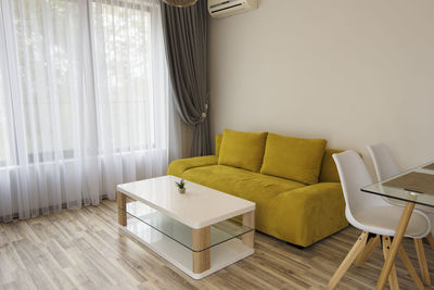 Empty chairs and table against wall at home