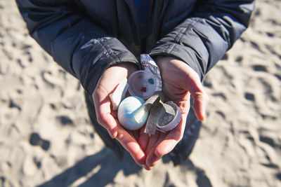 Closeup of hands holding ocean plastic trash waste at the beach
