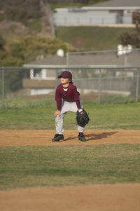 Little league baseball boy in ready position in the infield