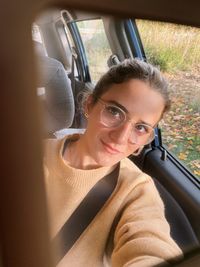 Portrait of mature woman sitting in car