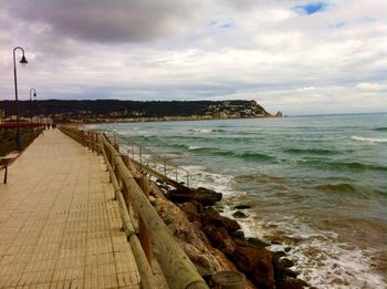 View of calm sea against cloudy sky