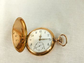 High angle view of pocket watch on table