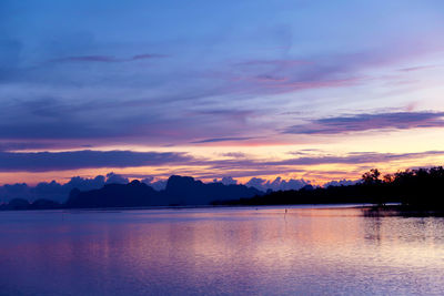 Scenic view of lake against romantic sky at sunset