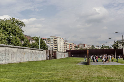 People in park by city against sky