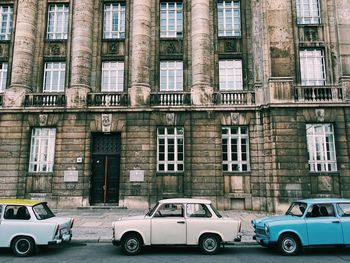 Cars on road against buildings in city