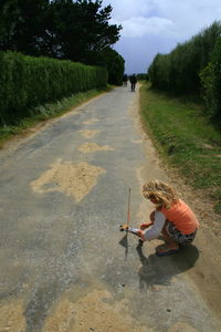 Full length of woman on road against sky