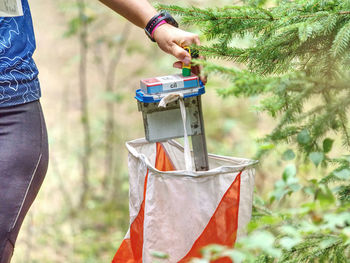 Cil is target. orienteering check point prism and spiky composter hang on tree branch, orienteering 