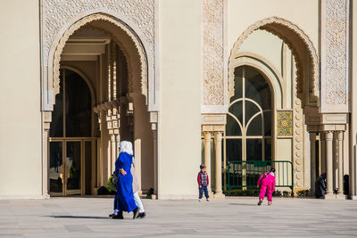 Rear view of people walking in a building