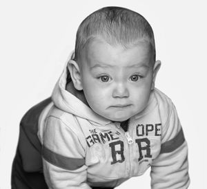 Portrait of cute boy against white background
