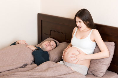 Young woman lying on bed at home